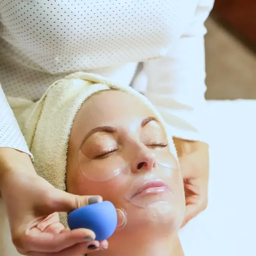 Hydrodermabrasion handpiece working across the cheek during a facial at Perfecta by Marina Stejar, Scottsdale AZ